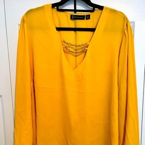 Yellow blouse with gold link accent
